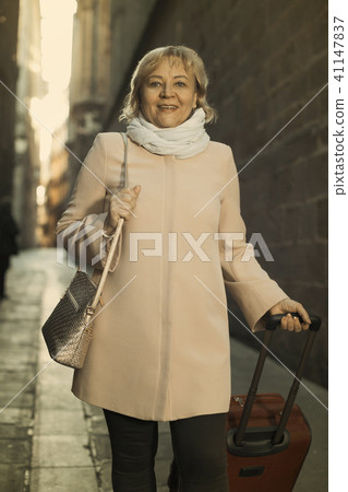 Female in the old city in scarf and coat 41147837