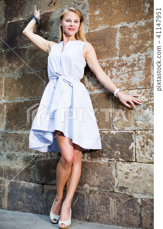 cheerful woman near the brick wall 41147951