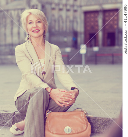 Adult woman 50-60 years old is sitting in time walking Adult woman 50-60 years old is sitting in time walking 41147990