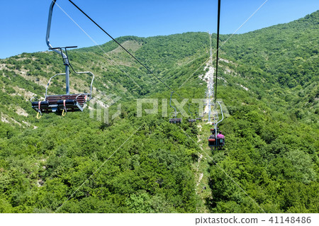 Chairlift going up the mountain. Beautiful sunset Chairlift going up the mountain. Beautiful sunset 41148486
