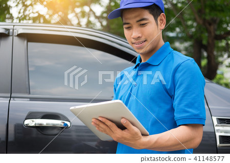Delivery man checking document list on clipboard outdoor and Car Delivery man checking document list on clipboard outdoor and Car 41148577