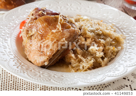 Pork knuckle with fried sauerkraut and tomatoes 41149853