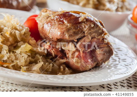 Pork knuckle with fried sauerkraut and tomatoes Pork knuckle with fried sauerkraut and tomatoes 41149855