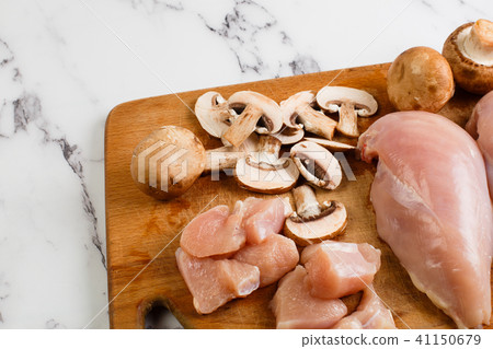 raw chicken fillets on wooden cutting board raw chicken fillets on wooden cutting board 41150679
