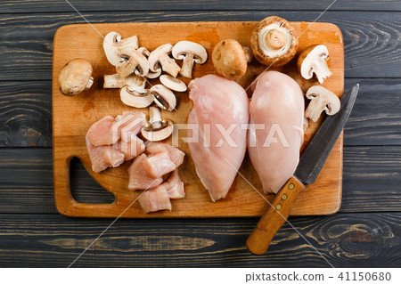 raw chicken fillets on wooden cutting board 41150680