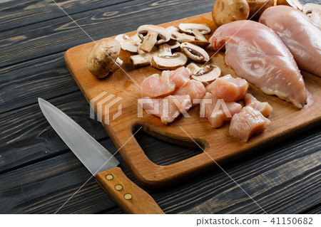 raw chicken fillets on wooden cutting board raw chicken fillets on wooden cutting board 41150682