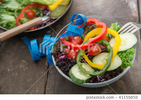 Fresh vegetables salad on  bowl with measuring  41150850