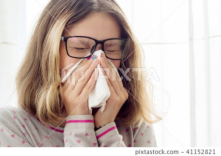 Sick teen girl with handkerchief at the home 41152821