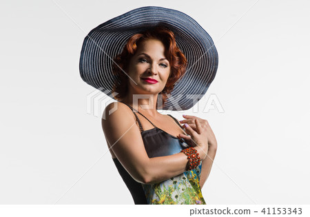 Portrait of mature woman with red hair and a hat. 41153343
