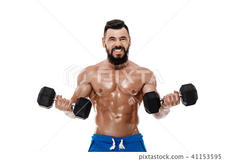 muscular man doing exercises with dumbbells. 41153595