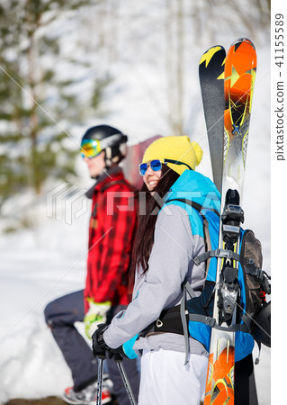 Image of sports men and women with mountain skis walking on snow hill 41155589