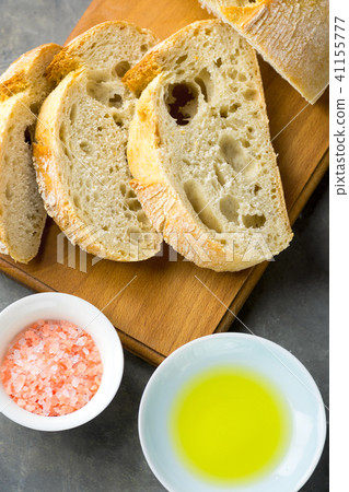 Sliced Artisan Rustic Bread on Wood Cutting Board Sliced Artisan Rustic Bread on Wood Cutting Board 41155777