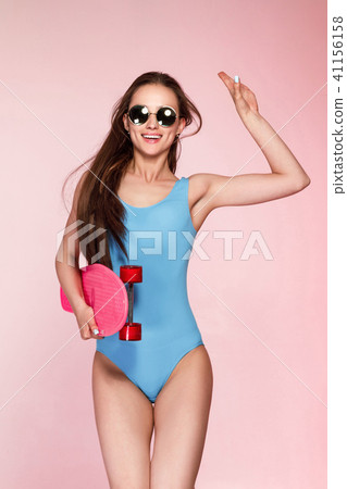 beautiful woman holding skateboard beautiful woman holding skateboard 41156158