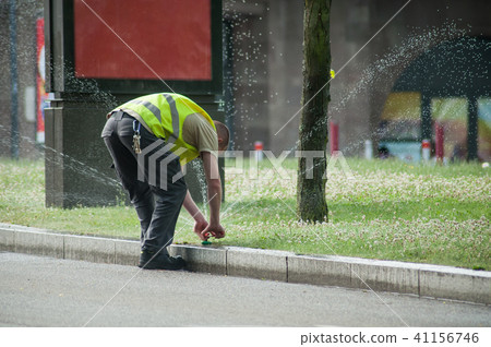 employee adjusting automatic sprinklers  41156746