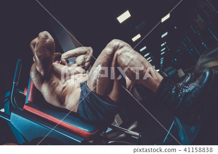 Handsome model young man training legs in gym Handsome model young man training legs in gym 41158838