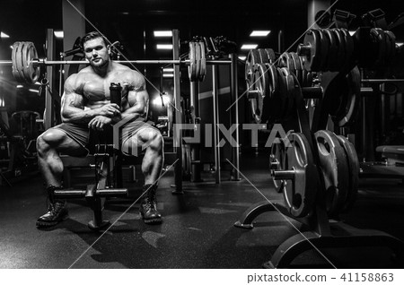 Handsome model young man training legs in gym Handsome model young man training legs in gym 41158863