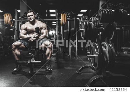Handsome model young man training legs in gym Handsome model young man training legs in gym 41158864