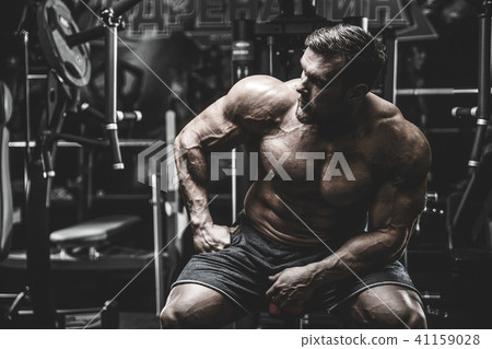 Handsome model young man training back in gym 41159028