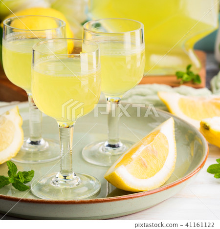 Home made limoncello in stemmed glasses 41161122