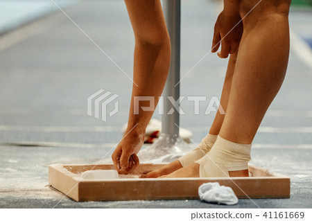 female gymnast rubs chalk on his legs female gymnast rubs chalk on his legs 41161669