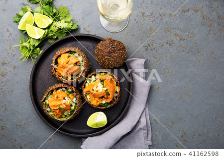 Fresh opened sea urchins. Caviar of sea urchins with onion, cilantro and lemon inside of shell of Fresh opened sea urchins. Caviar of sea urchins with onion, cilantro and lemon inside of shell of 41162598