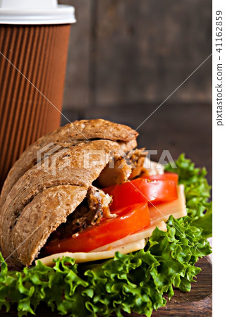 grain croissant sandwich and a cardboard cup  41162859
