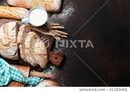 Various crusty bread and cup of milk Various crusty bread and cup of milk 41163069