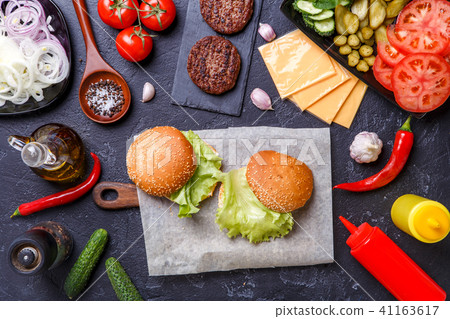 Photo on top of two hamburgers and ingredients 41163617