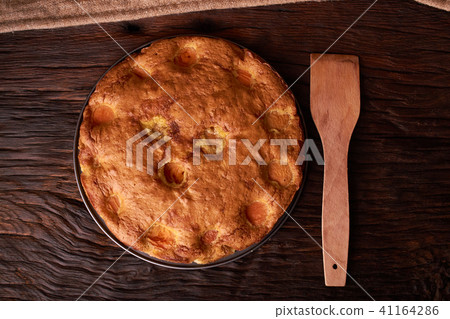 Apricot cake or pie with a wooden shovel. top view Apricot cake or pie with a wooden shovel. top view 41164286