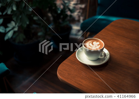 Flat white coffee latte art on wooden table 41164966