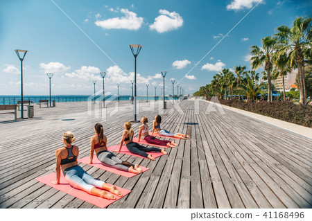 Slim girls stretching their body near the sea 41168496