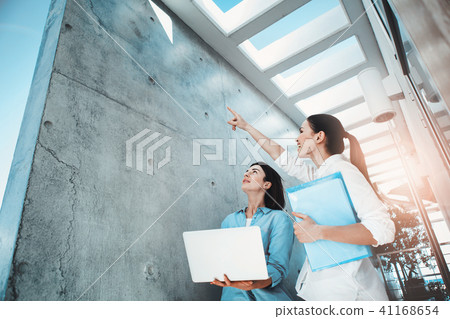 Female colleagues rejoicing in sunbeam Female colleagues rejoicing in sunbeam 41168654