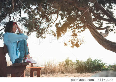 Melancholic girl is resting near big three 41169028