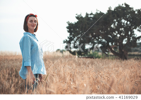 Attractive young woman is walking in the nature 41169029