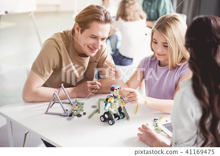 Outgoing man and children making toy 41169475