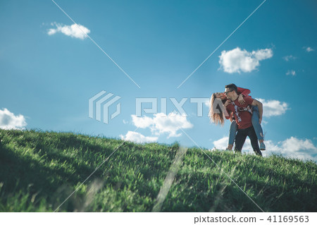 Girl on back of boyfriend in nature 41169563