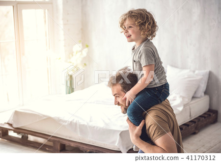Doting father is cuddling kid in light dormitory Doting father is cuddling kid in light dormitory 41170312