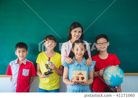 shoolkids and teacher standing in classroom shoolkids and teacher standing in classroom 41171060