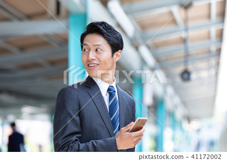 Businessman walking on the station platform Mid-level employee business image 41172002