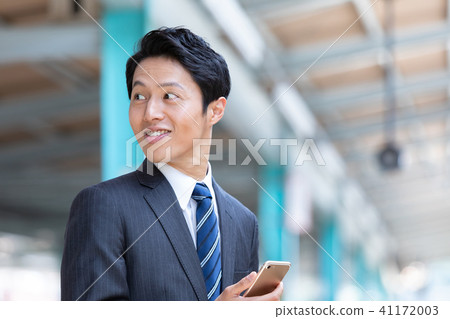 Businessman walking on the station platform Mid-level employee business image Businessman walking on the station platform Mid-level employee business image 41172003