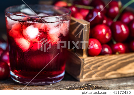 Fresh cherries in a wooden box, ice, cherry juice Fresh cherries in a wooden box, ice, cherry juice 41172420
