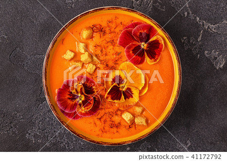 Pumpkin / carrot soup with saffron and flowers Pumpkin / carrot soup with saffron and flowers 41172792
