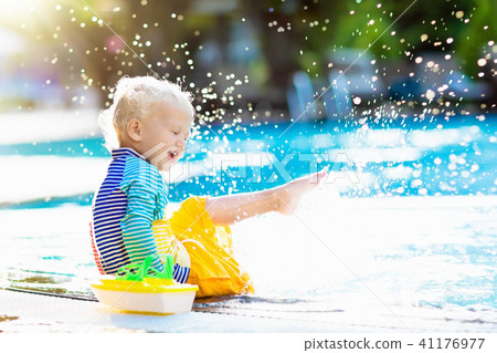 Baby in swimming pool. Family summer vacation. 41176977