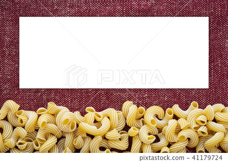 Macaroni rigati Beautiful decomposed pasta from the bottom on a rustic red-brown textured background 41179724