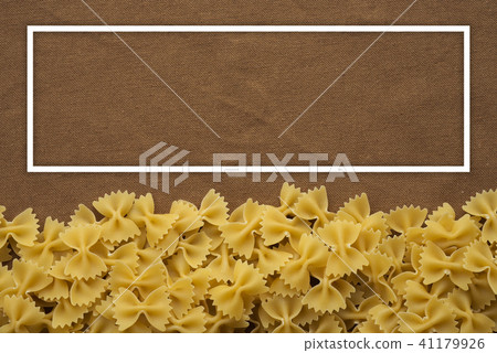 farfalle macaroni Beautiful decomposed pasta from the bottom on a rustic brown textured background farfalle macaroni Beautiful decomposed pasta from the bottom on a rustic brown textured background 41179926