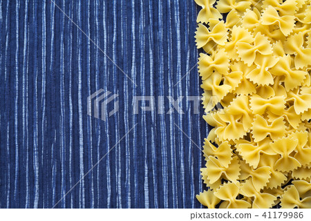 farfalle macaroni Beautiful decomposed pasta with the right, on its side on a rustic red-brown farfalle macaroni Beautiful decomposed pasta with the right, on its side on a rustic red-brown 41179986