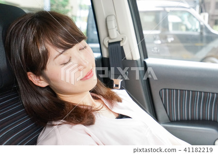 A woman sleeping in a car A woman sleeping in a car 41182219