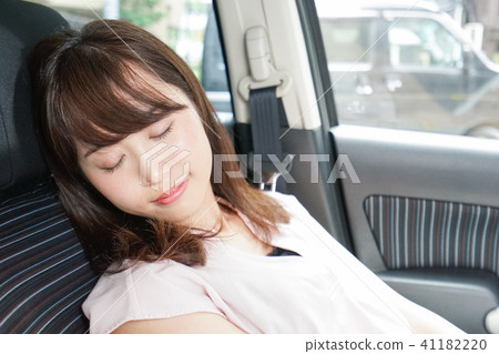 A woman sleeping in a car A woman sleeping in a car 41182220