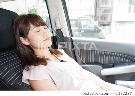 A woman sleeping in a car A woman sleeping in a car 41182227