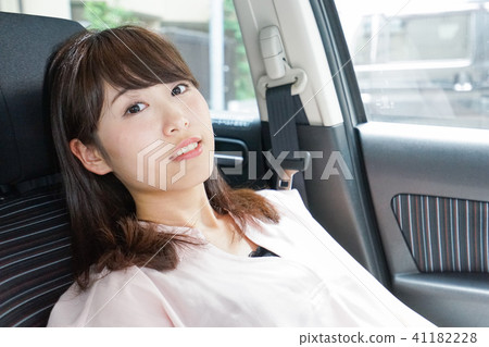 A woman sleeping in a car A woman sleeping in a car 41182228
